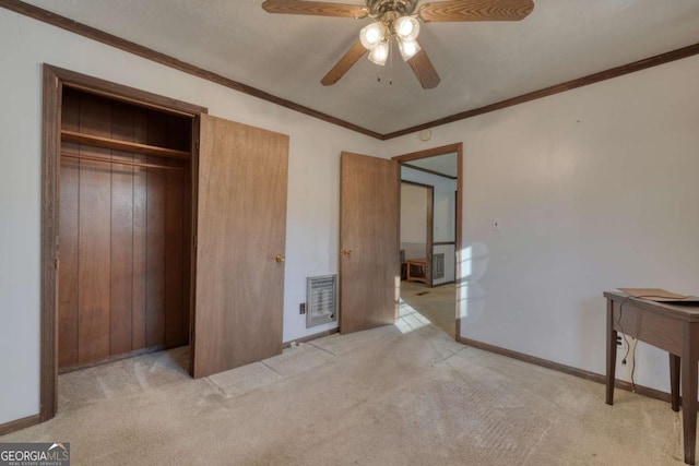 unfurnished bedroom featuring baseboards, ceiling fan, ornamental molding, carpet, and a closet