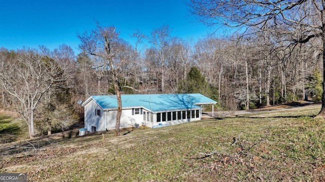 exterior space with a yard, a chimney, and a forest view