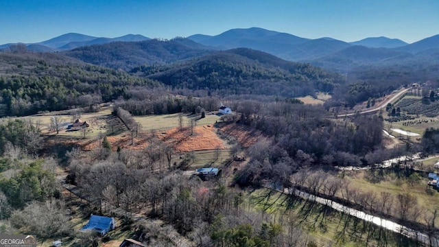 birds eye view of property featuring a mountain view and a view of trees