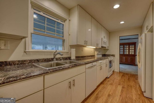 kitchen featuring recessed lighting, white appliances, a sink, white cabinets, and light wood finished floors