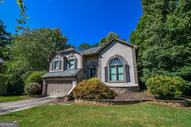 view of front of house featuring a garage, a front yard, concrete driveway, and stucco siding