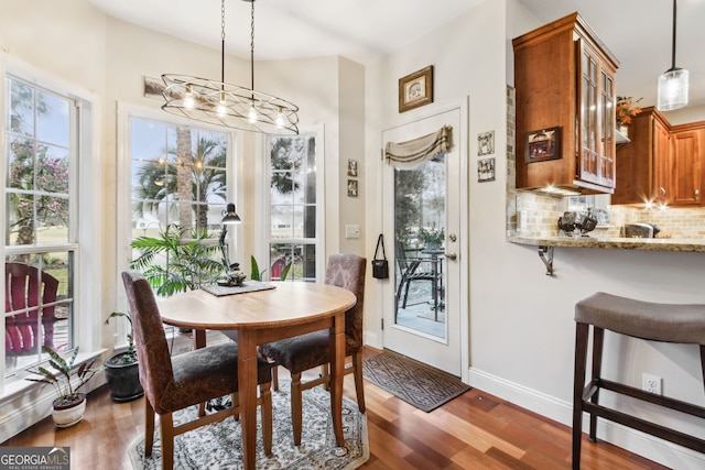 dining space featuring baseboards and wood finished floors