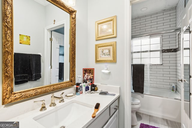 bathroom featuring bathing tub / shower combination, vanity, and toilet