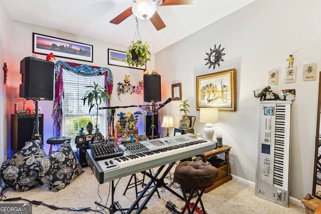 playroom with carpet, ceiling fan, and baseboards