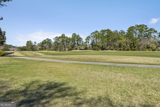 surrounding community featuring a yard and golf course view