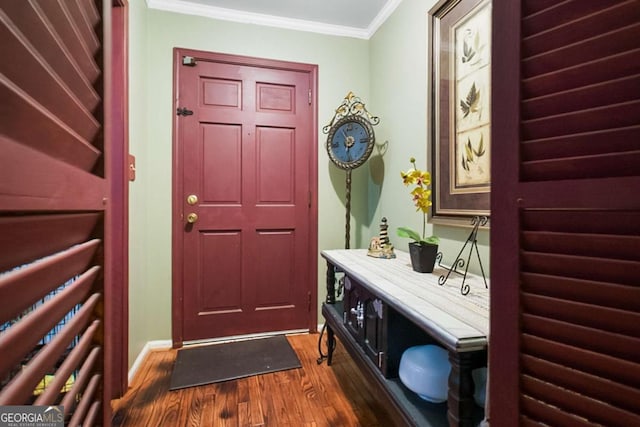 doorway with crown molding and dark wood-type flooring