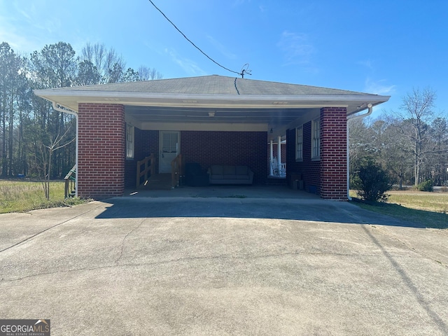 exterior space with driveway and an attached carport