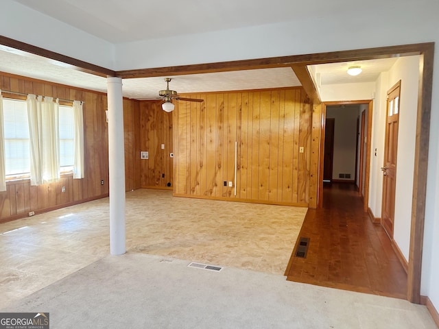 interior space with visible vents, wood walls, and decorative columns