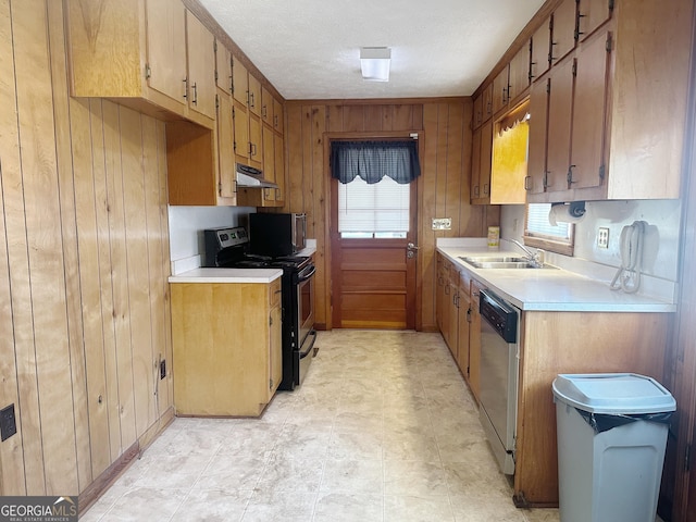 kitchen featuring dishwasher, black / electric stove, light countertops, under cabinet range hood, and a sink