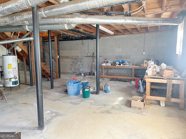 unfinished below grade area with gas water heater and concrete block wall