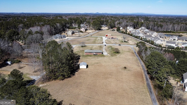 birds eye view of property with a wooded view