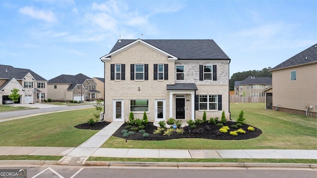 view of front facade with brick siding, a front yard, fence, and a residential view