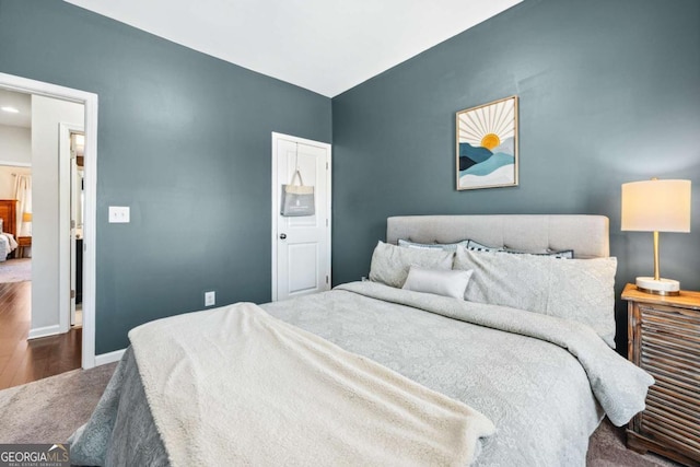 bedroom featuring dark wood-type flooring and baseboards