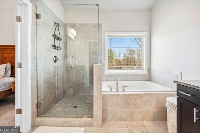 ensuite bathroom with ensuite bathroom, a shower stall, vanity, tile patterned flooring, and a bath