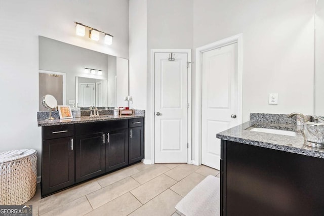 full bathroom featuring two vanities, a sink, and tile patterned floors