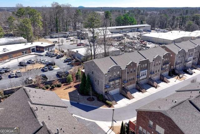 drone / aerial view with a wooded view