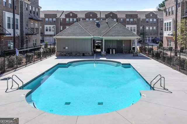 pool featuring fence and a patio