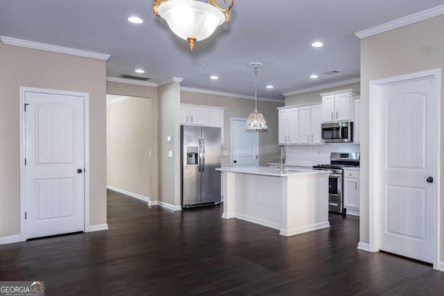 kitchen with stainless steel appliances, dark wood-type flooring, a kitchen island with sink, white cabinets, and a sink