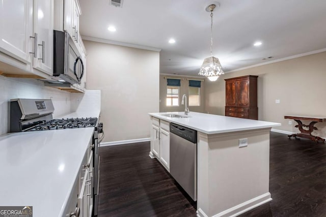 kitchen featuring appliances with stainless steel finishes, backsplash, a sink, and dark wood finished floors