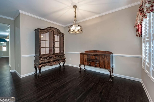 unfurnished dining area with baseboards, ornamental molding, and wood finished floors