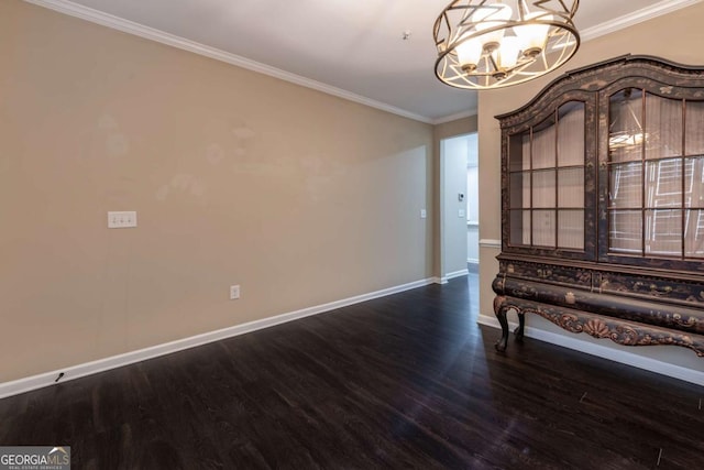 interior space featuring ornamental molding, an inviting chandelier, baseboards, and wood finished floors