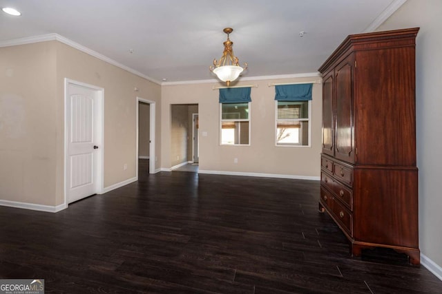 spare room featuring ornamental molding, dark wood finished floors, and baseboards