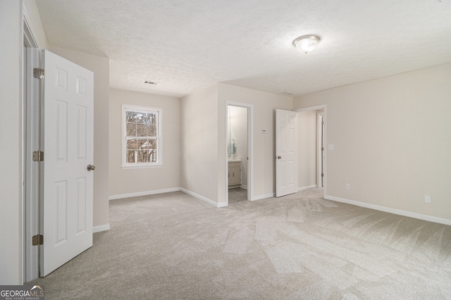 unfurnished bedroom featuring light carpet, visible vents, and baseboards