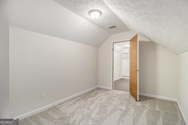 bonus room with baseboards, visible vents, lofted ceiling, a textured ceiling, and carpet floors