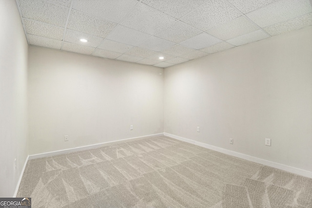 unfurnished room featuring recessed lighting, light carpet, a drop ceiling, and baseboards