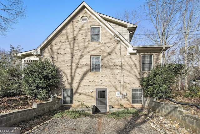 back of house with brick siding