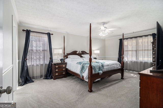 bedroom featuring a textured ceiling, carpet flooring, and crown molding