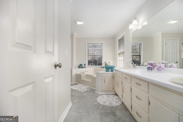 bathroom featuring crown molding, a garden tub, a sink, and double vanity