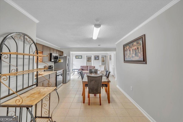 dining room with light tile patterned floors, baseboards, ornamental molding, and a textured ceiling