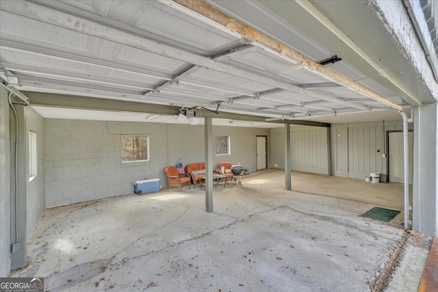 garage with concrete block wall and a garage door opener