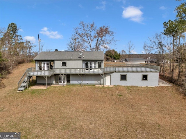 back of property with a yard, stairs, a deck, and french doors