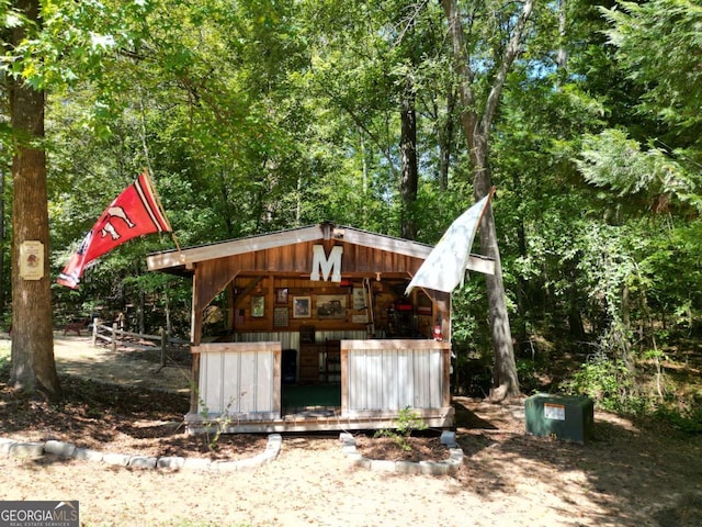 view of outdoor structure with a wooded view