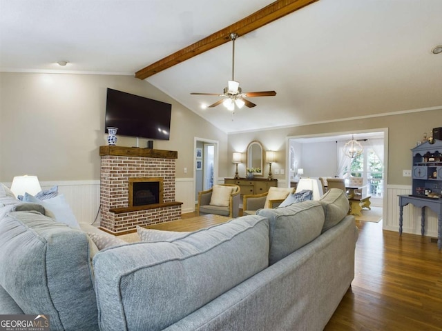 living room featuring dark wood-style flooring, a wainscoted wall, vaulted ceiling with beams, and a fireplace