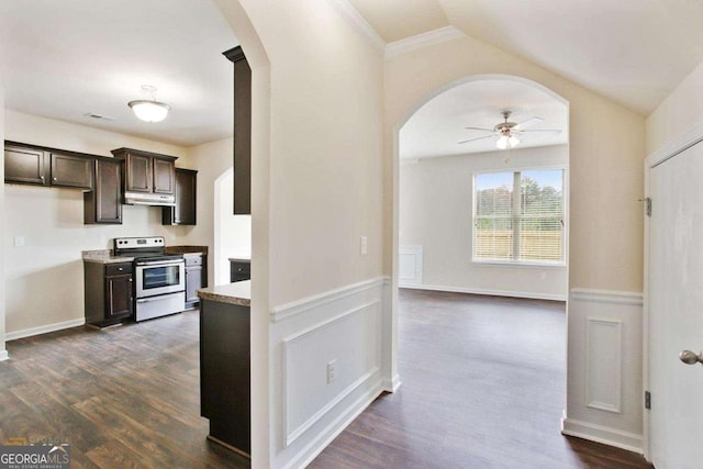 kitchen featuring arched walkways, electric range, dark brown cabinets, wainscoting, and dark wood finished floors