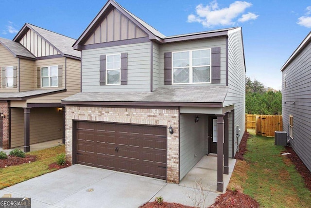 view of front of home with brick siding, an attached garage, board and batten siding, fence, and driveway