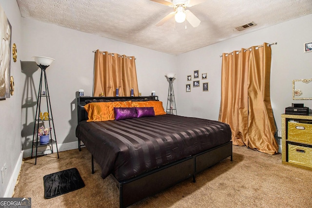 bedroom with baseboards, visible vents, carpet floors, and a textured ceiling