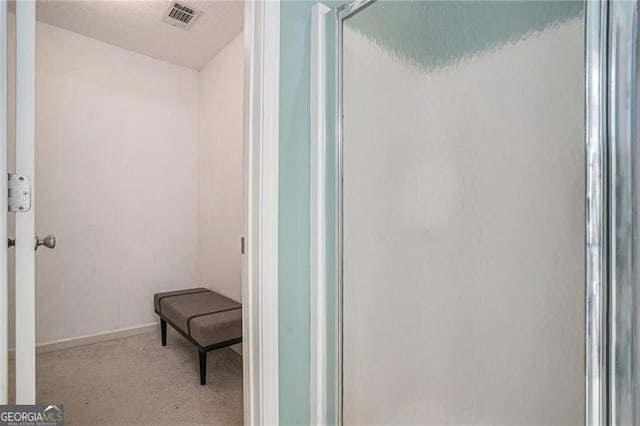 190 The Falls Blvd, Covington, GA 30016 - bathroom featuring a textured ceiling, baseboards, and an enclosed shower