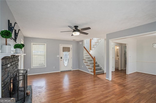 190 The Falls Blvd, Covington, GA 30016 - foyer featuring wood finished floors, stairs, ceiling fan, a textured ceiling, and baseboards