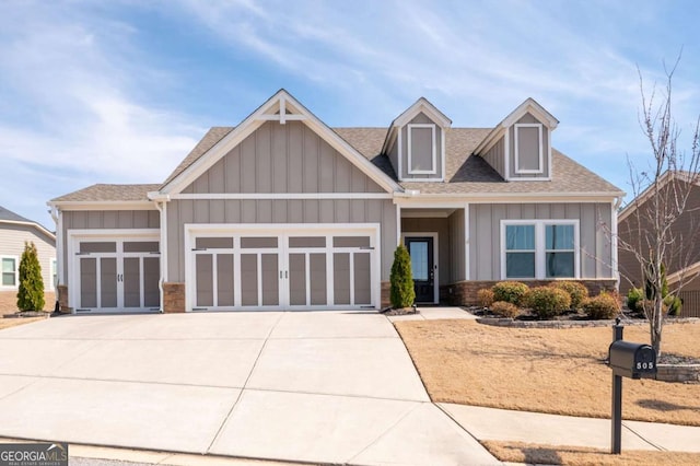 craftsman-style house with a garage, a shingled roof, board and batten siding, and concrete driveway