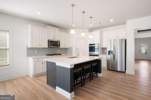 kitchen featuring white cabinetry, appliances with stainless steel finishes, and a sink