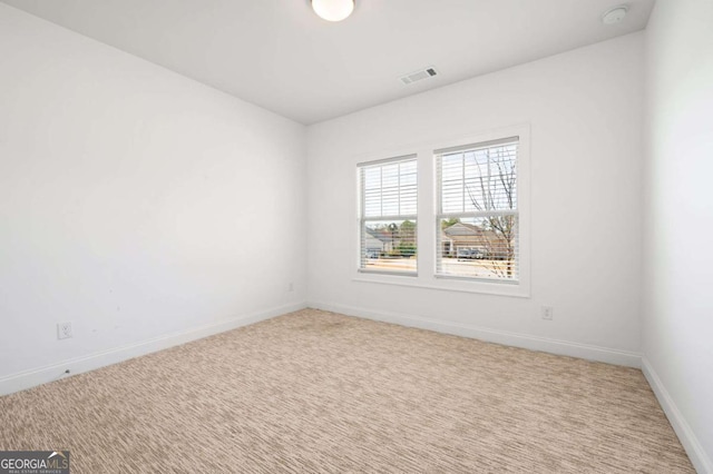 carpeted empty room with baseboards and visible vents