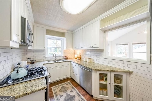 kitchen with a sink, white cabinetry, and stainless steel appliances