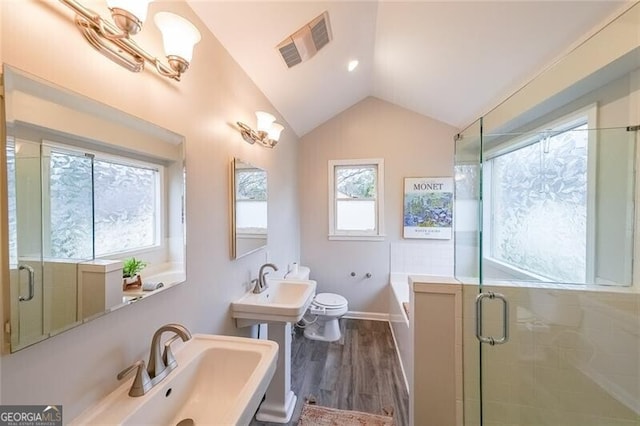 full bath featuring visible vents, toilet, a stall shower, wood finished floors, and lofted ceiling