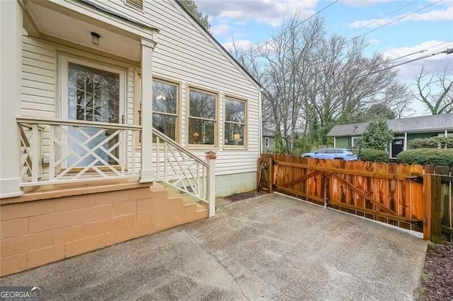 view of side of home featuring a patio area and fence