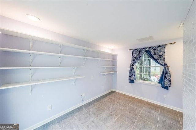 unfurnished room with baseboards