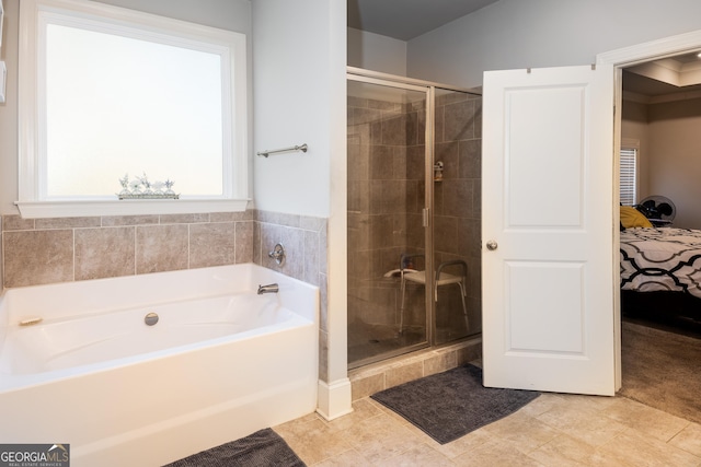 ensuite bathroom with a garden tub, a shower stall, tile patterned flooring, and ensuite bathroom